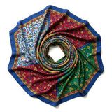 This image showcases a cross-section of a spiral shell featuring a mesmerizing array of colors and intricate patterns. The vibrant hues range from pink, blue, and green near the center to yellow, orange, and brown towards the outer edges, creating a stunn